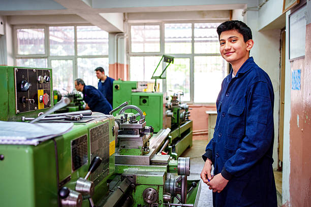 A teen in a machining workshop