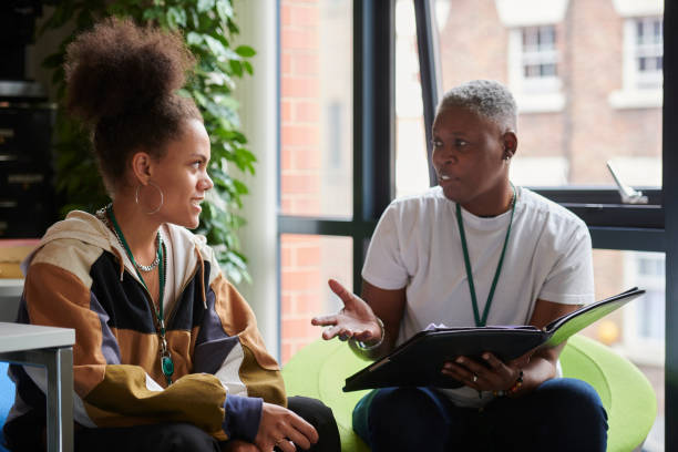 A mentor talking with a teen